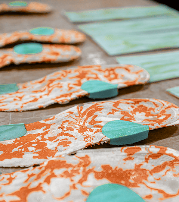 Custom, orange, blue and white Therapeutic Orthotic Inserts for diabetic shoes and footwear.